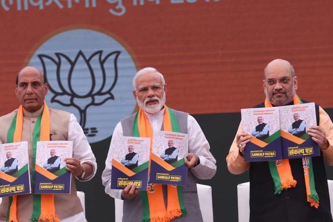 General Election 2019 Bjp Has Copy Pasted Its 2014 Document - bjp president amit shah right prime minister narendra modi and union home minister