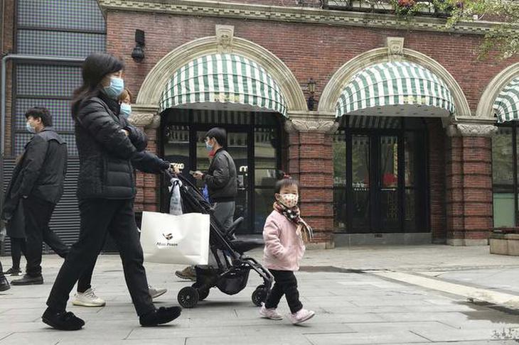 Residents wearing masks visit a shopping street in Wuhan in central China’s Hubei province
