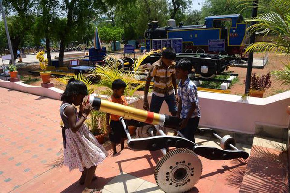 Children having a look at a canon made out of scrap and kept on display at the rail museum in Tiruchi on Monday.