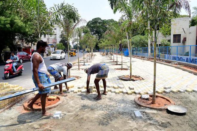 Workers engaged in beautification work at the roadside park on Lawsons Road in Tiruchi on Tuesday.