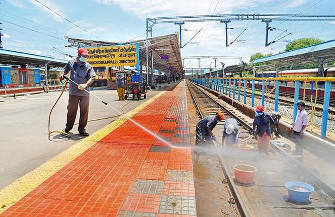 Workers engaged in cleaning the platform and the railway track at Tiruchi railway junction on Tuesday.