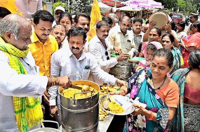 TDP MLA V.R.K. Babu serving meals to the poor outside the Anna Canteen at MVP Colony in Visakhapatnam .