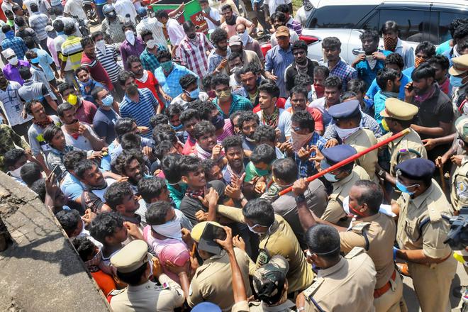 Police try to stop the villagers from entering LG Polymers plant at RR Venkatapuram in Visakhapatnam.