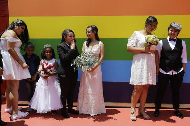 In this file photo, same sex couples wait to get married prior to a group marriage of forty same sex couples in Sao Paulo, Brazil.