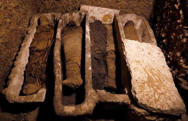 Mummies are seen inside a tomb during the presentation of a new discovery at Tuna el-Gebel archaeological site in Minya Governorate, Egypt. File