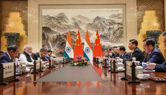 Prime Minister Narendra Modi during a meeting with Chinese President Xi Jinping and other officials during his visit in Wuhan, China.