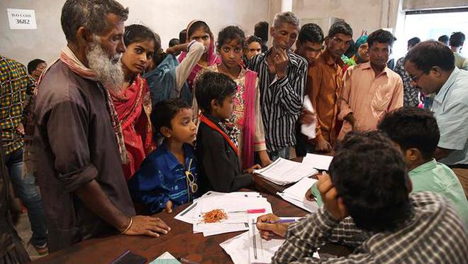 A file photo of NRC officials checking documents of residents during a hearing against the non-inclusion of names.