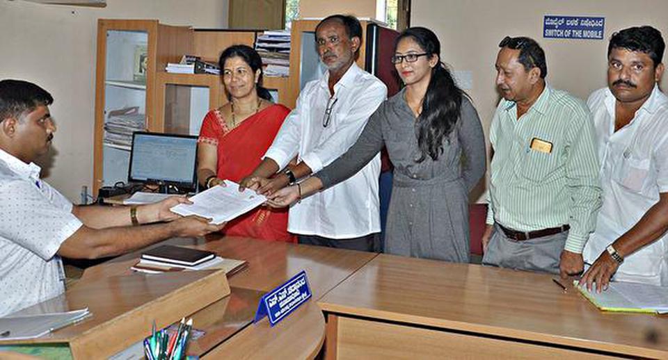 Shankare Gowda, popularly known as ‘Five Rupees Doctor’, submitting his nomination papers for Mandya Assembly constituency election in Mandya on Monday.