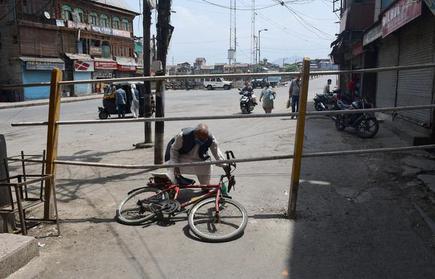 A man crosses a barricade during lockdown reimposed in Srinagar on July 13, 2020.
