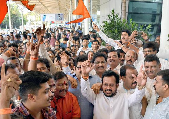 Celebration time: Shiv Sena members celebrating after Devendra Fadanvis declared his resignation as Chief Minister on Tuesday.