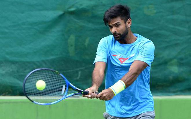 Making the most of it: Jeevan Nedunchezhiyan is spending time hitting at private courts and handling the marketing of their family resort .